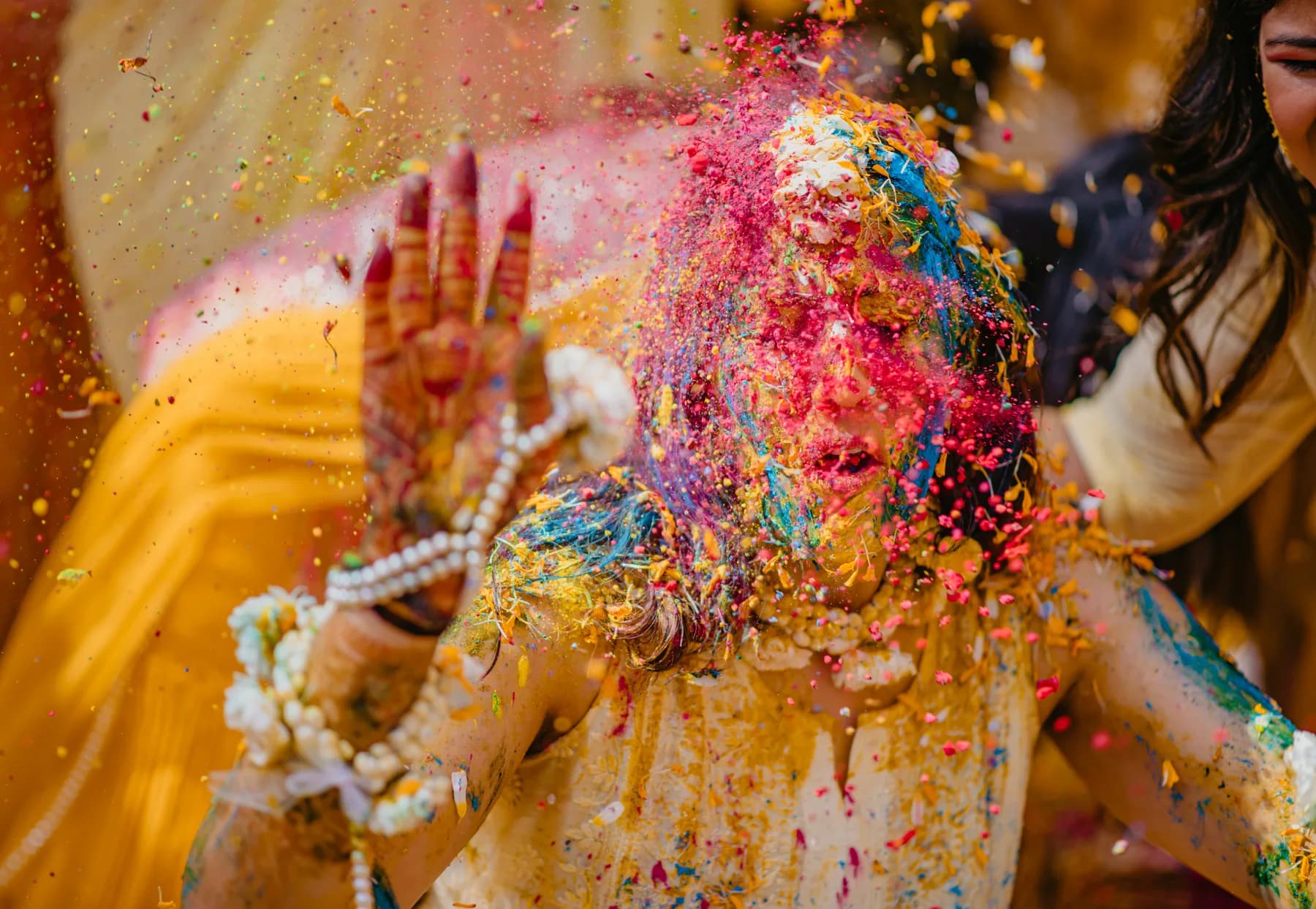 Guests throwing turmeric during a haldi ceremony